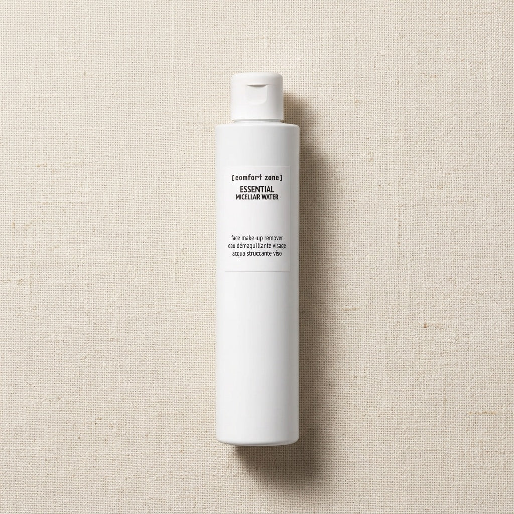Comfort Zone Essential Persian Water bottle, a tall white cylindrical plastic bottle with a white cap, standing vertically on a textured beige linen background.
