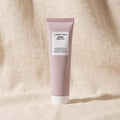 A gentle cleanser for sensitive skin in a pink tub with a white label